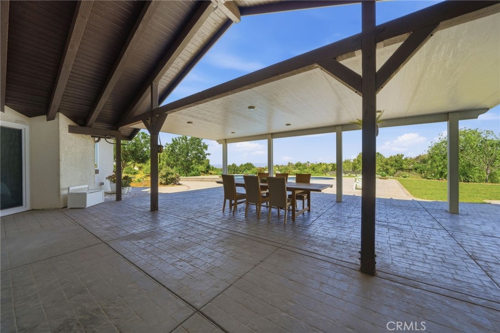 41110 Los Ranchos Circle Temecula, CA 92592 - Photo 50 of 77 a view of a porch with chairs and backyard