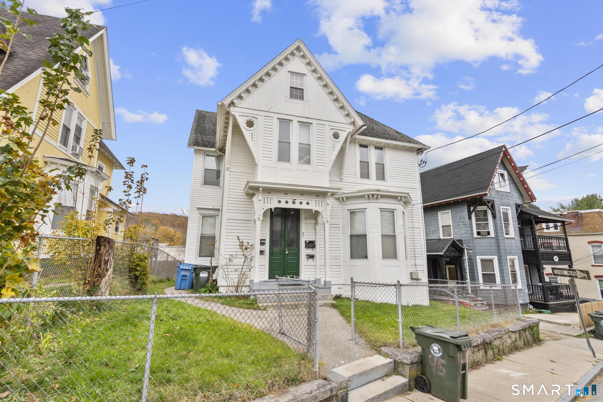 a front view of a house with swimming pool having outdoor seating