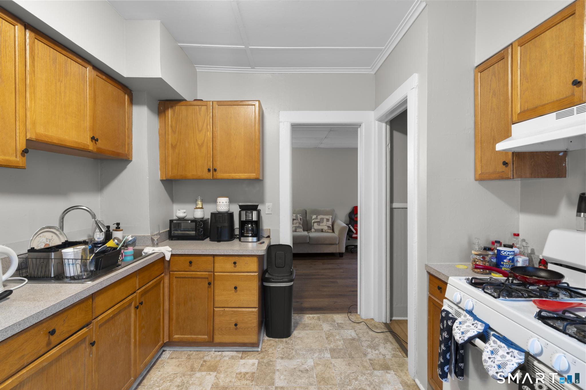 45 Cliff Street Norwich, CT 06360 - Photo 11 of 39 a kitchen with a sink stove and cabinets