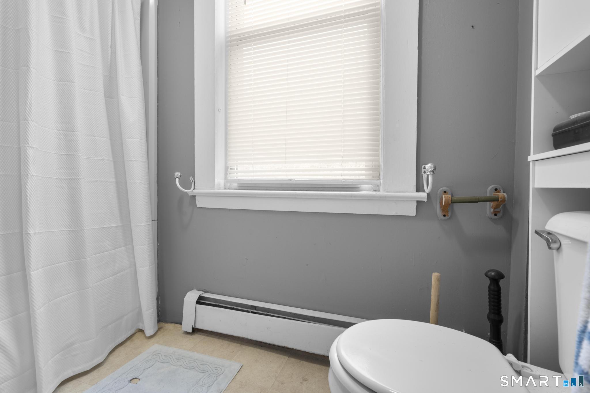 45 Cliff Street Norwich, CT 06360 - Photo 18 of 39 a white toilet and a window