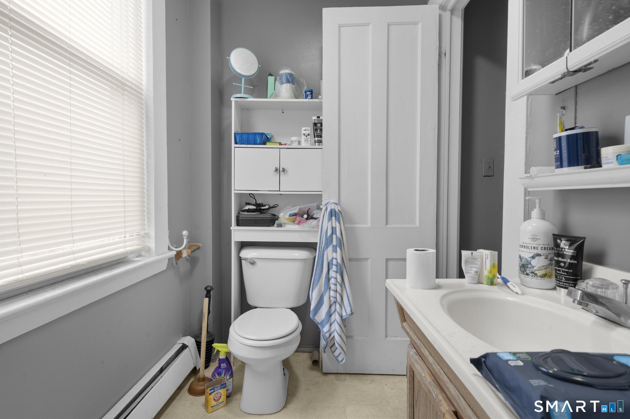 45 Cliff Street Norwich, CT 06360 - Photo 19 of 39 a white toilet sitting next to a bathroom sink