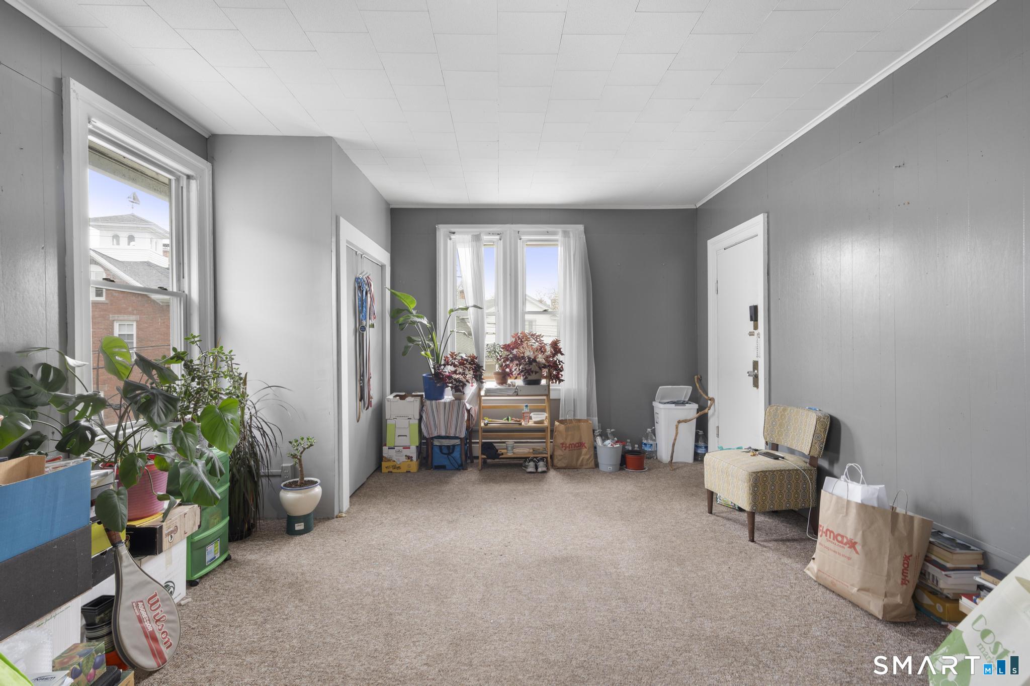 45 Cliff Street Norwich, CT 06360 - Photo 22 of 39 a living room with furniture and a potted plant