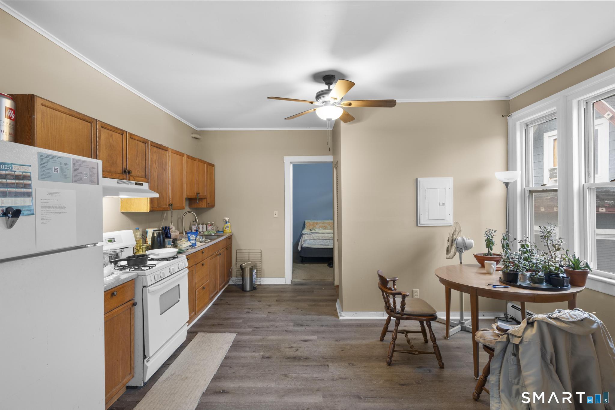 45 Cliff Street Norwich, CT 06360 - Photo 23 of 39 a kitchen with stainless steel appliances a stove a sink a dining table and chairs