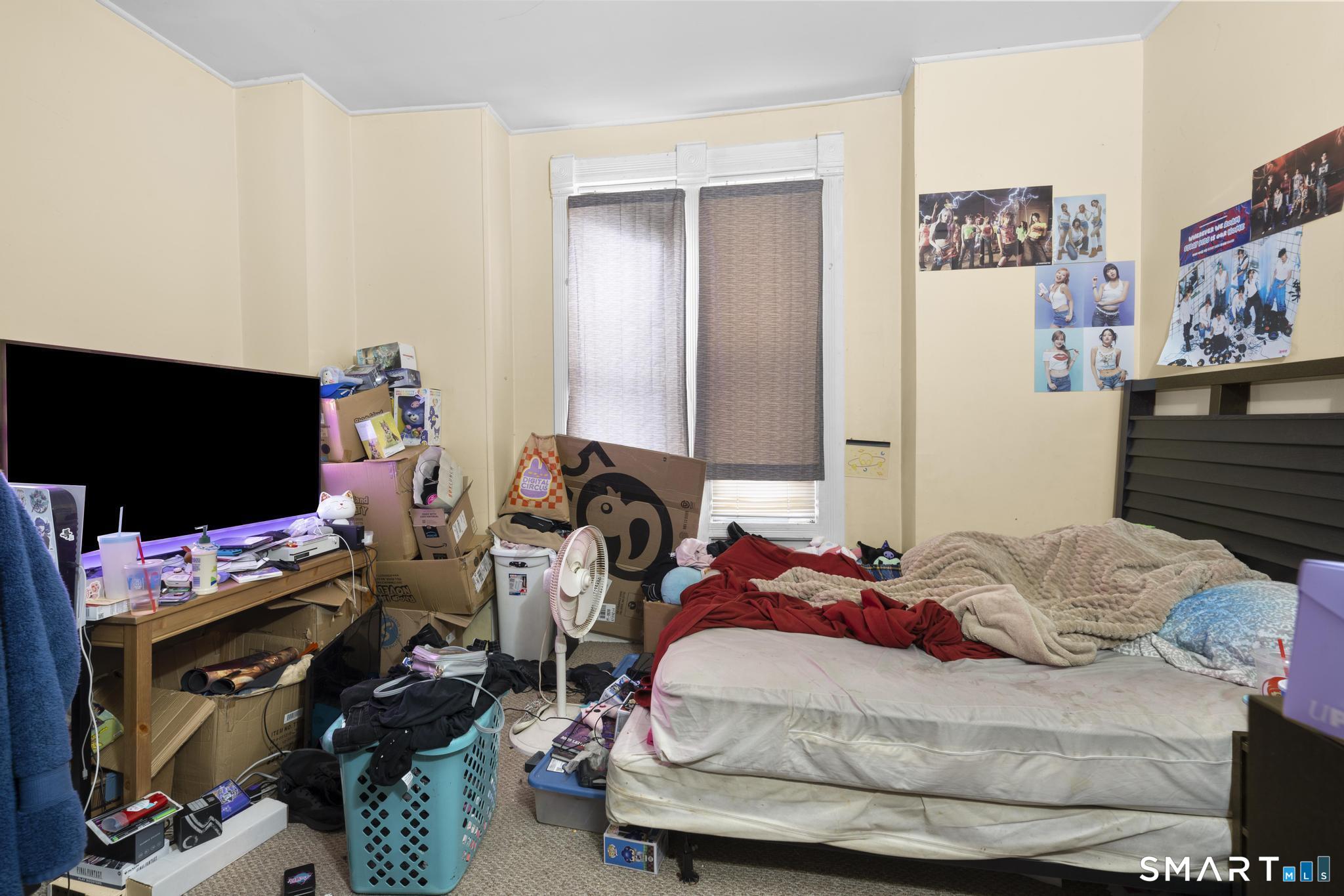 45 Cliff Street Norwich, CT 06360 - Photo 33 of 39 a bedroom with a bed and a flat screen tv