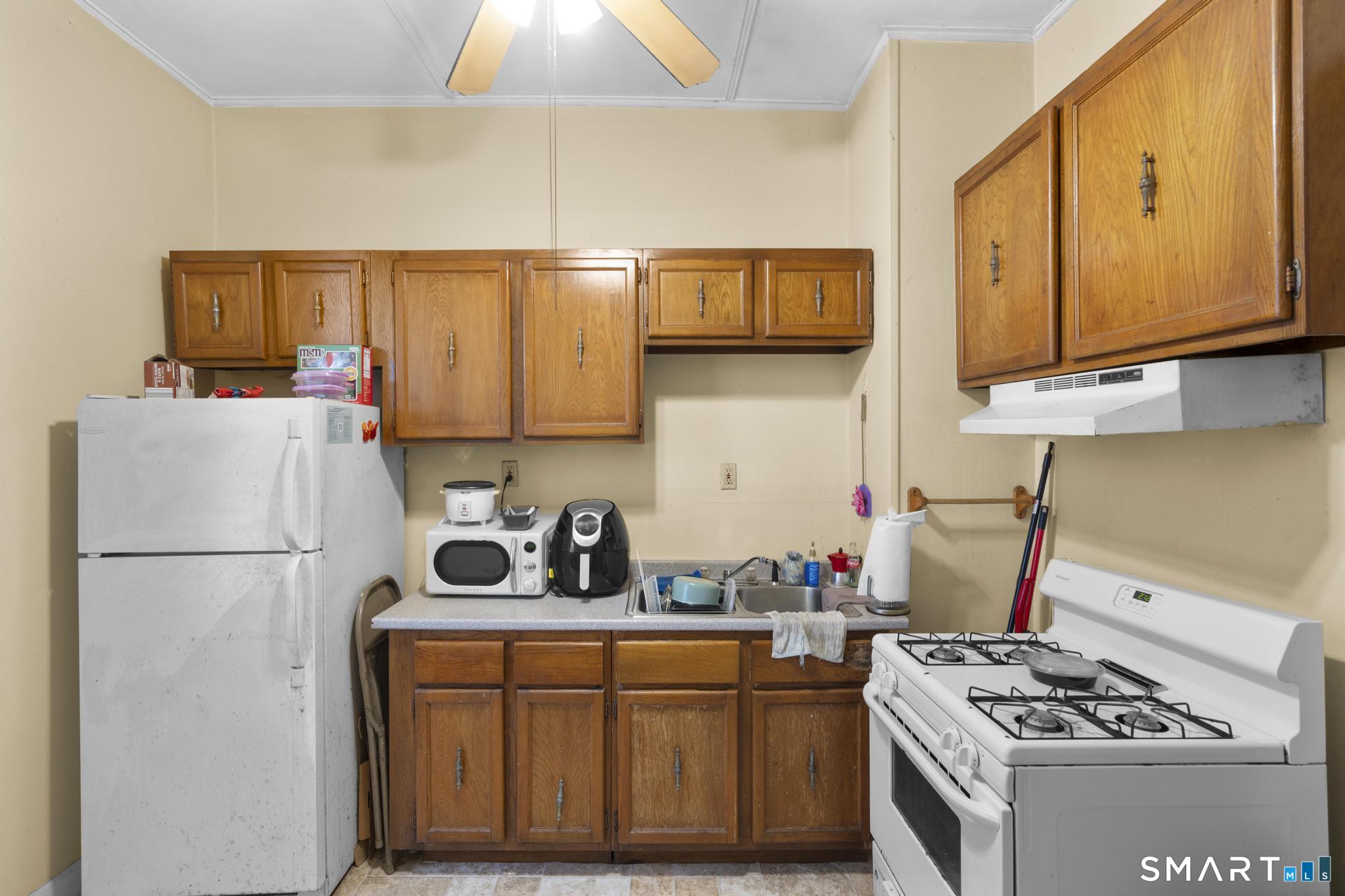 45 Cliff Street Norwich, CT 06360 - Photo 36 of 39 a kitchen with stainless steel appliances granite countertop a sink stove and refrigerator