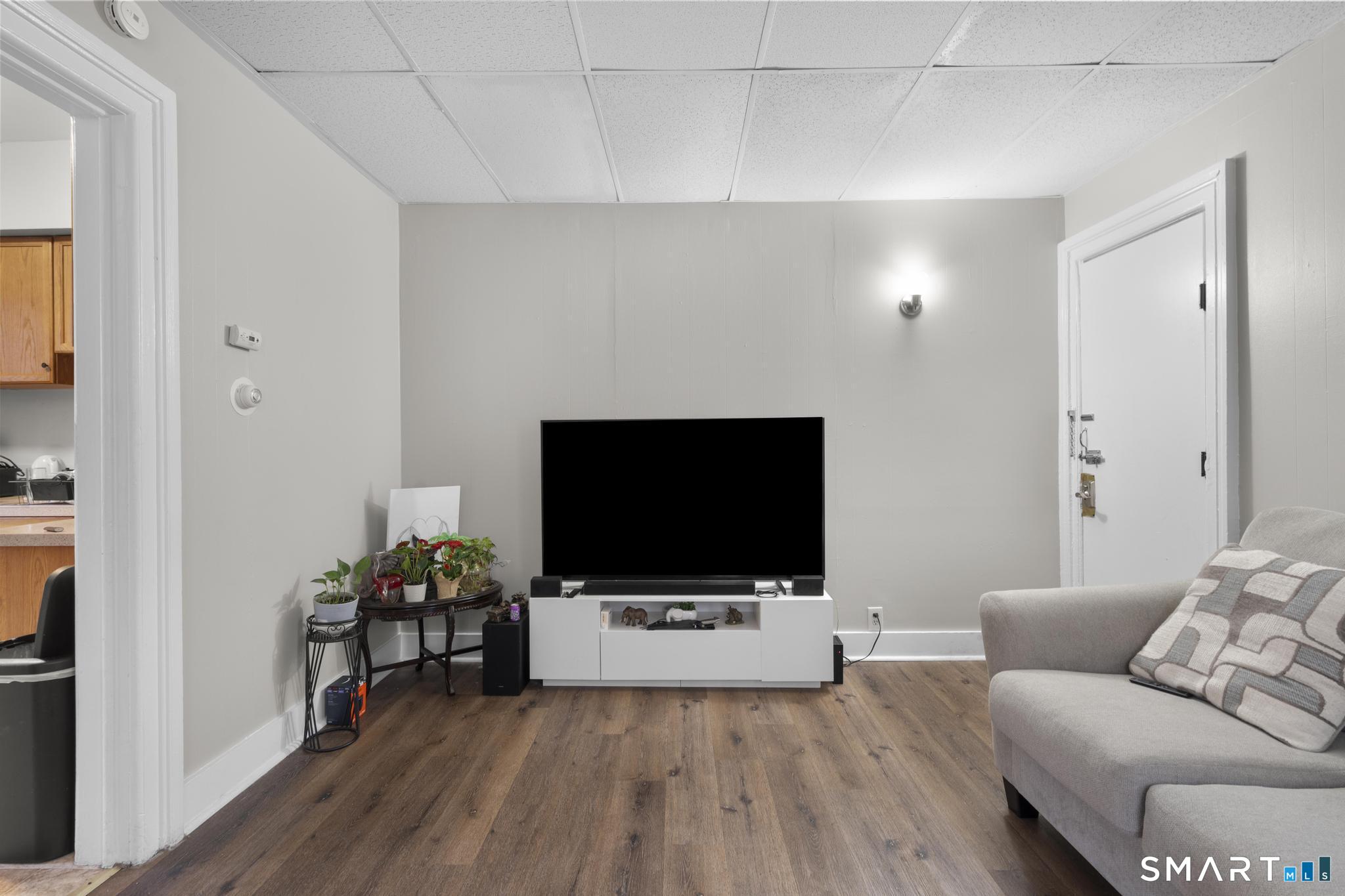 45 Cliff Street Norwich, CT 06360 - Photo 7 of 39 a living room with furniture and a flat screen tv