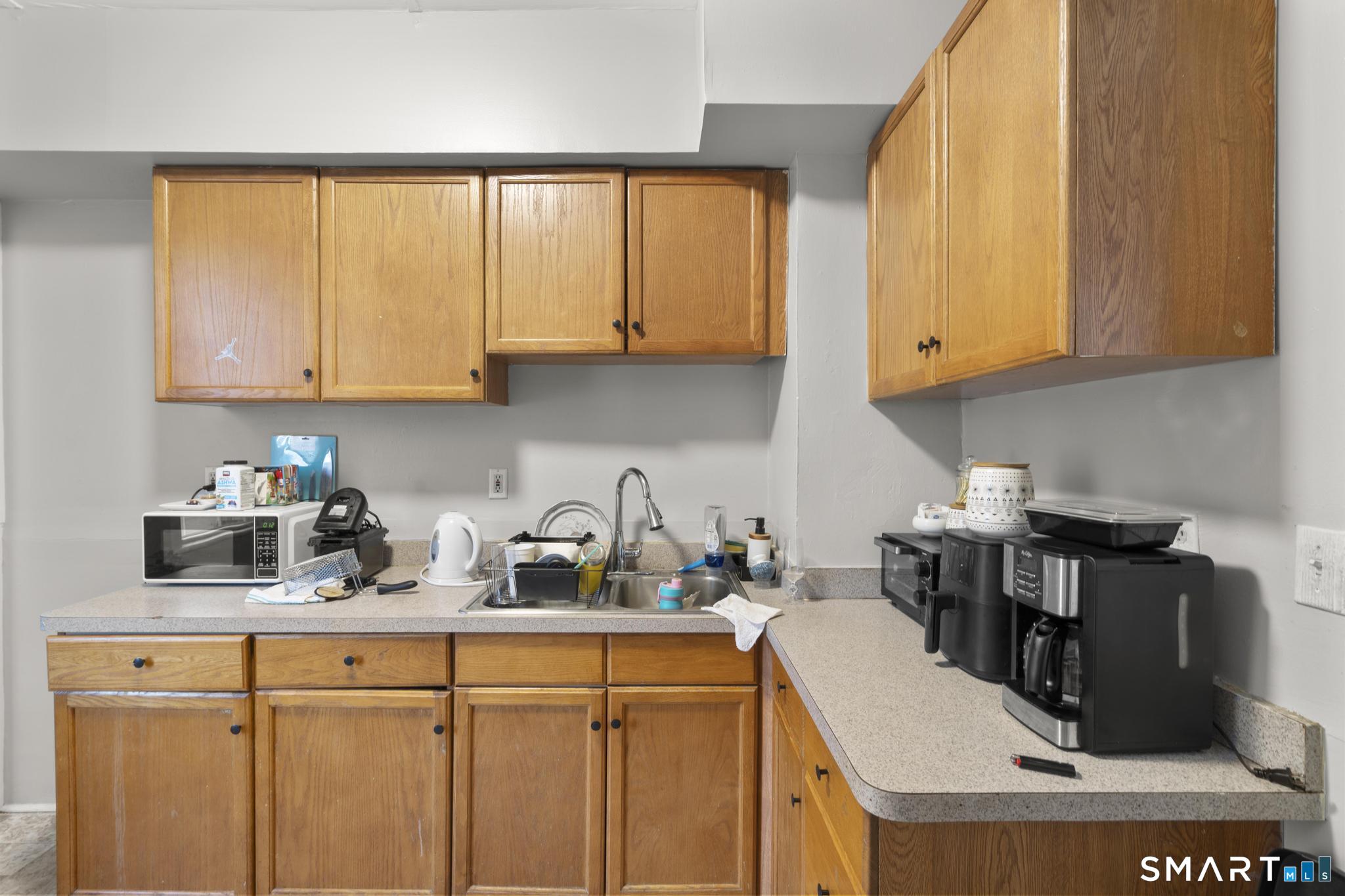 45 Cliff Street Norwich, CT 06360 - Photo 9 of 39 a kitchen with a stove a sink and a cabinets