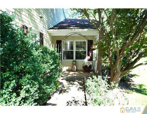 74 Woodbury Road Edison, NJ 08820 - Photo 2 of 23 a front view of a house with a garden