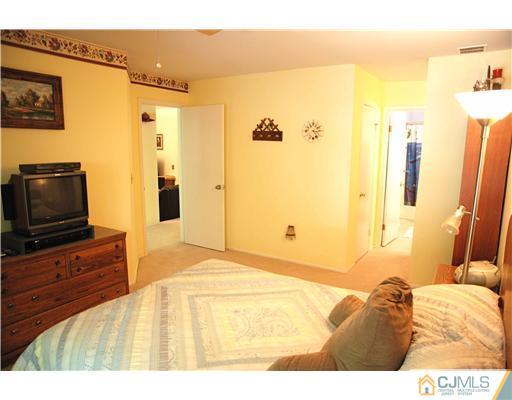 74 Woodbury Road Edison, NJ 08820 - Photo 11 of 23 a bedroom with a bed and wooden floor