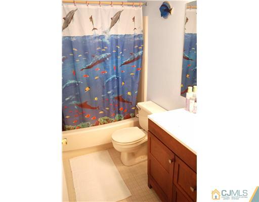 74 Woodbury Road Edison, NJ 08820 - Photo 12 of 23 a bathroom with a sink a toilet and shower