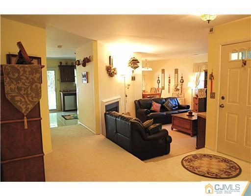 74 Woodbury Road Edison, NJ 08820 - Photo 15 of 23 a living room with furniture a rug and white walls
