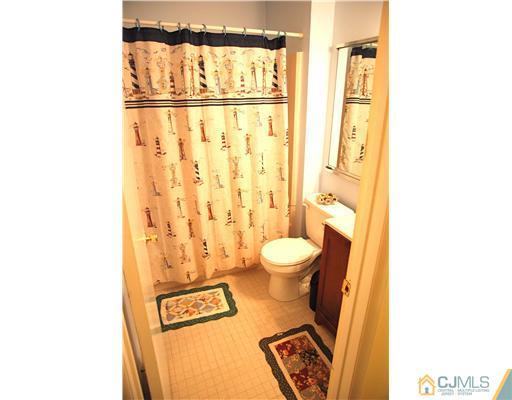 74 Woodbury Road Edison, NJ 08820 - Photo 18 of 23 a bathroom with a toilet and a shower