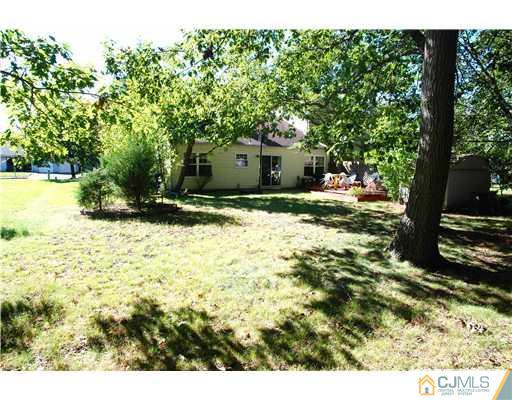 74 Woodbury Road Edison, NJ 08820 - Photo 23 of 23 a backyard of a house with yard and outdoor seating
