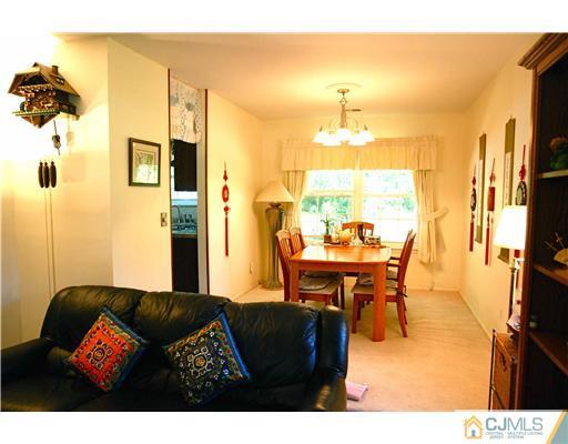 74 Woodbury Road Edison, NJ 08820 - Photo 4 of 23 a living room with furniture and a table