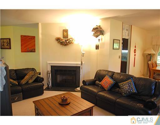 74 Woodbury Road Edison, NJ 08820 - Photo 7 of 23 a living room with furniture and a fireplace