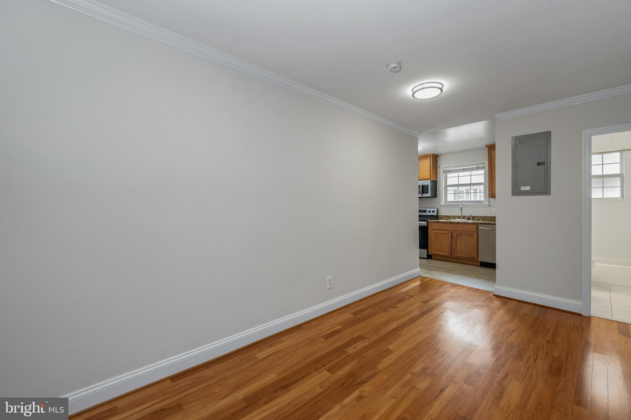 19 Post, Unit AVENUE 203 Laurel, MD 20707 - Photo 10 of 26 Living Room into Kitchen view