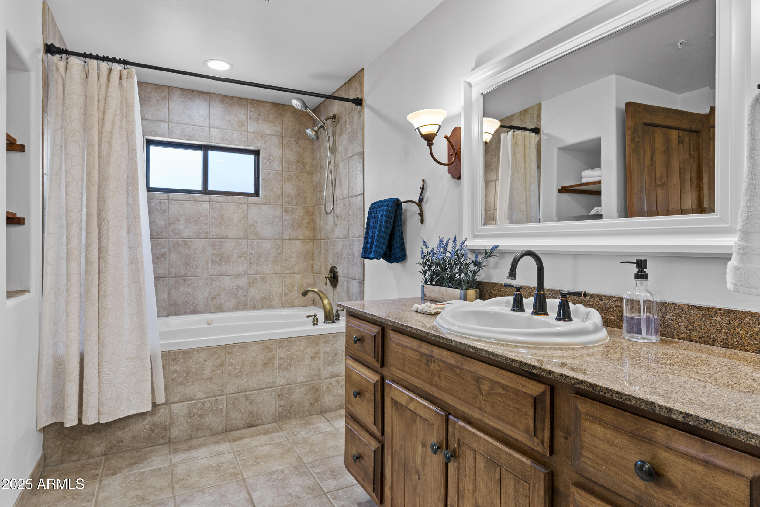 36601 North Mule Train Road, Unit D18 Carefree, AZ 85377 - Photo 26 of 57 a bathroom with a tub sink and mirror