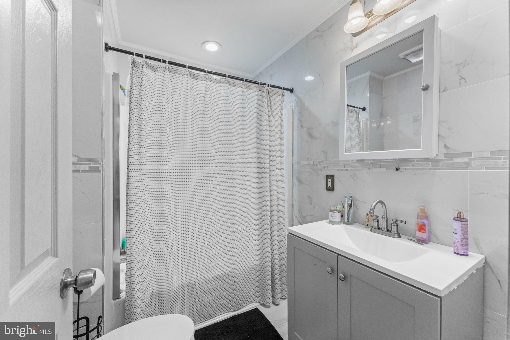 107 Hawthorne Avenue Ewing, NJ 08638 - Photo 13 of 18 a bathroom with a sink a toilet and shower