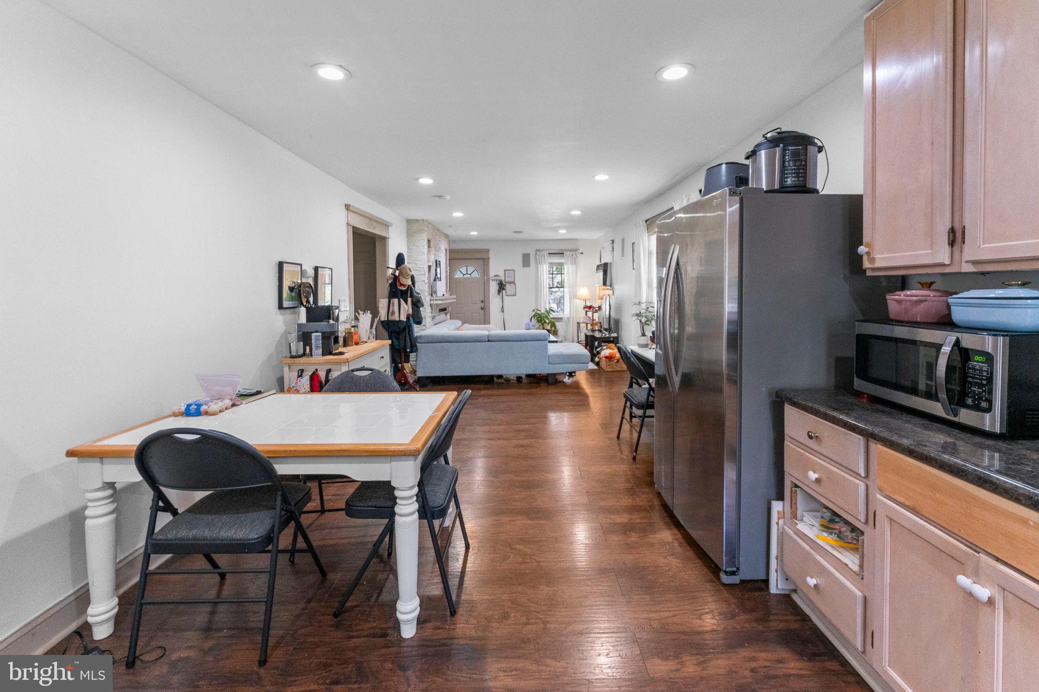 107 Hawthorne Avenue Ewing, NJ 08638 - Photo 9 of 18 a kitchen with stainless steel appliances a refrigerator a stove a sink dishwasher with a dining table and chairs