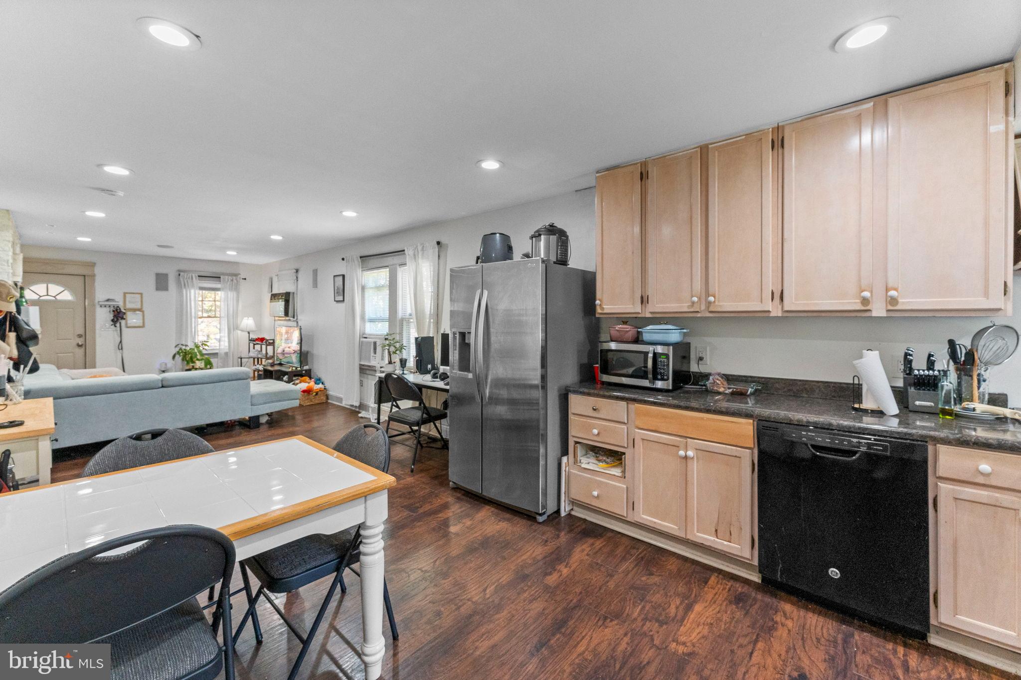 107 Hawthorne Avenue Ewing, NJ 08638 - Photo 10 of 18 a kitchen with stainless steel appliances granite countertop a refrigerator a stove top oven with a dining table and chairs