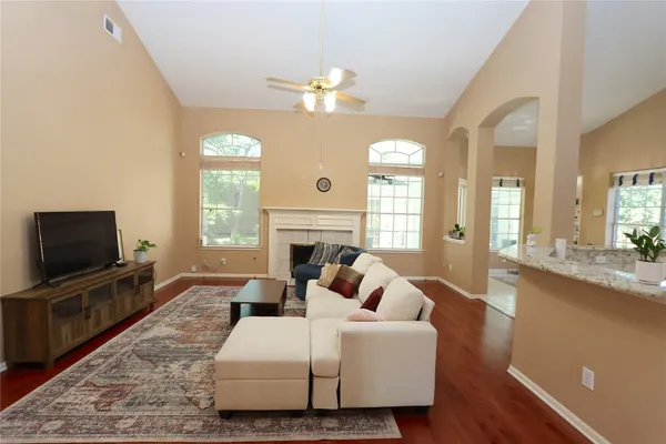 a living room with fireplace furniture and a flat screen tv