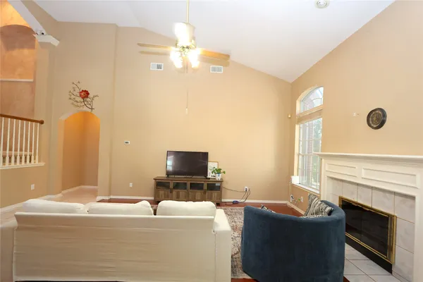 a living room with furniture and a fireplace