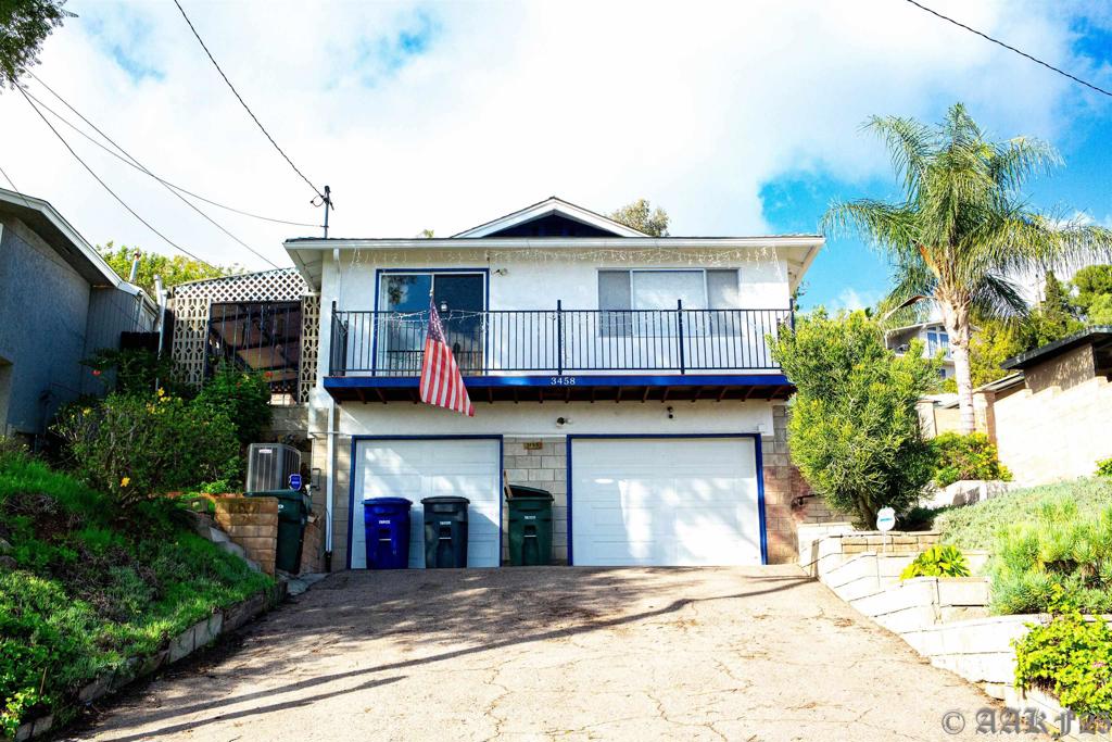 a view of a house with a yard and potted plants