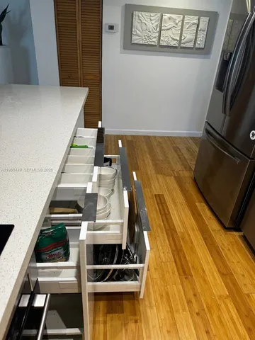 a view of a room with wooden floor
