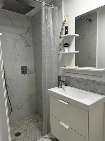 a bathroom with a sink toilet and shower