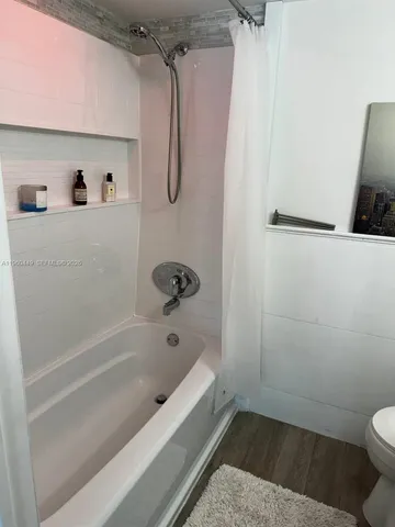 a bedroom with a bed and walk in closet