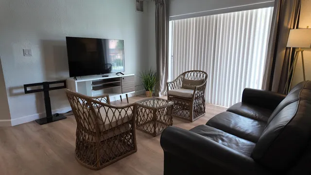 a view of a livingroom with furniture and a flat screen tv