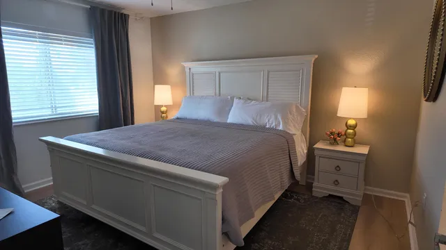 a spacious bedroom with a bed and a window