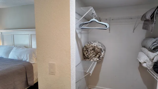 a bedroom with a bed and a table in it