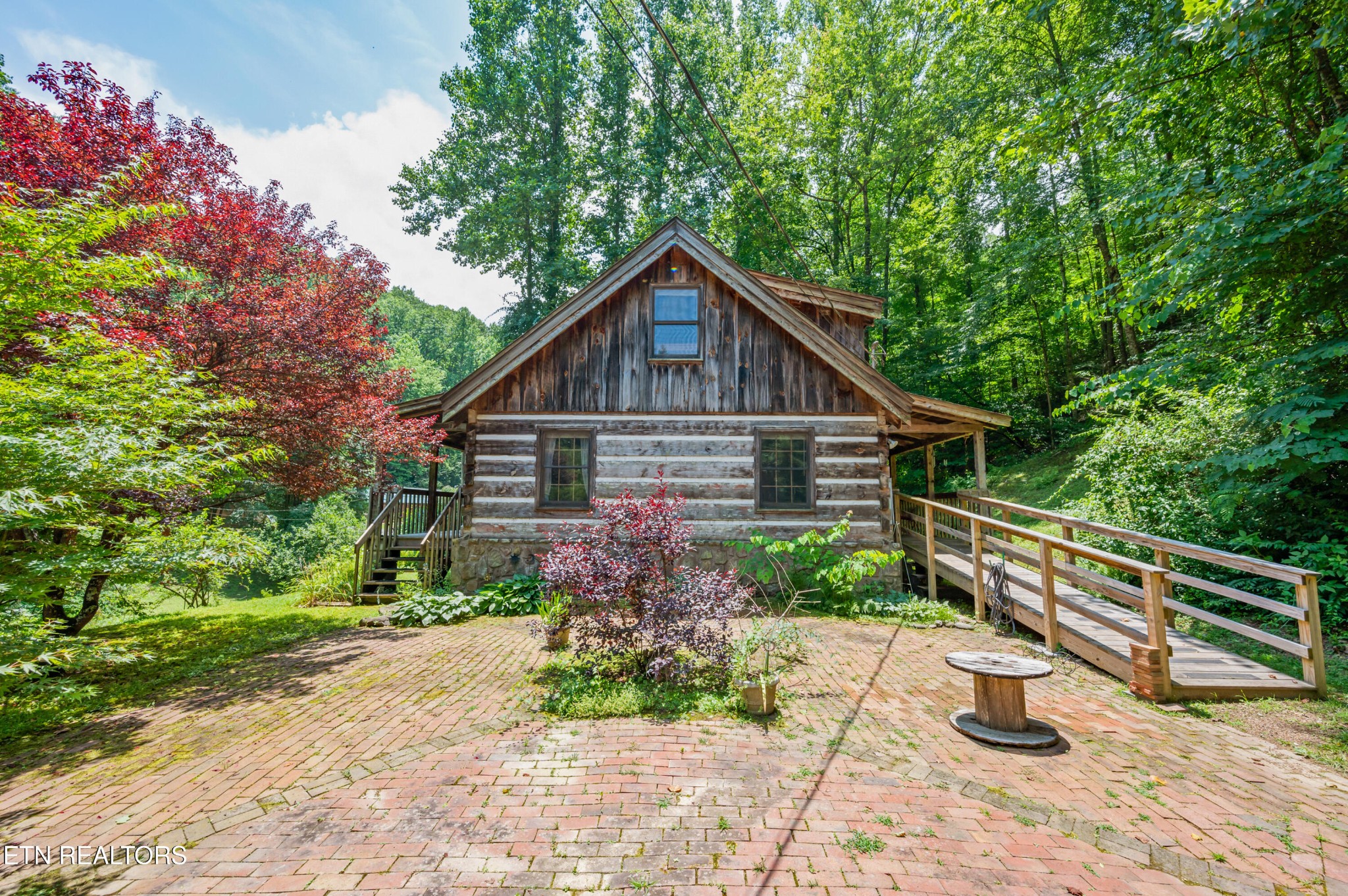 727 Hidden Valley Road Gatlinburg, TN 37738 - Photo 6 of 22 a front view of a house with porch