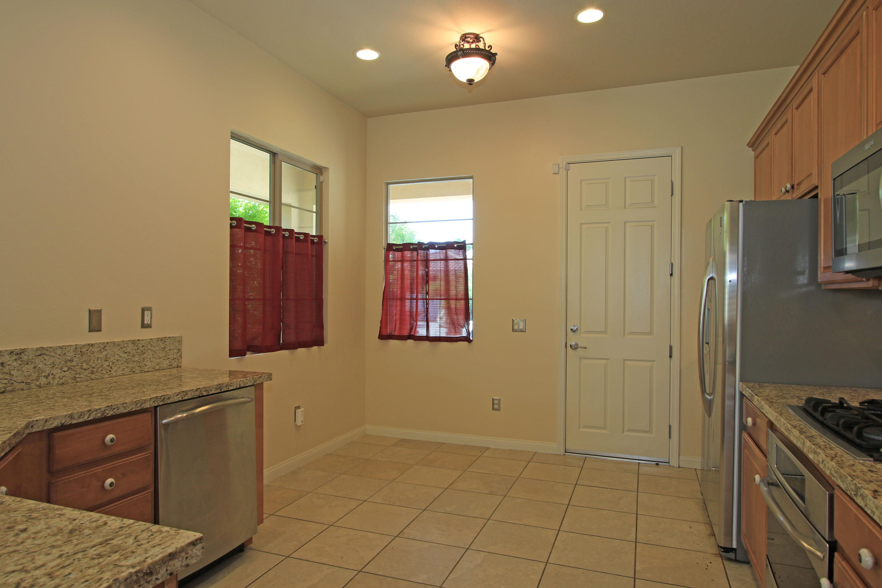 81642 Avenida Bolero Indio, CA 92203 - Photo 11 of 38 a room with stainless steel appliances kitchen island granite countertop a refrigerator and a sink