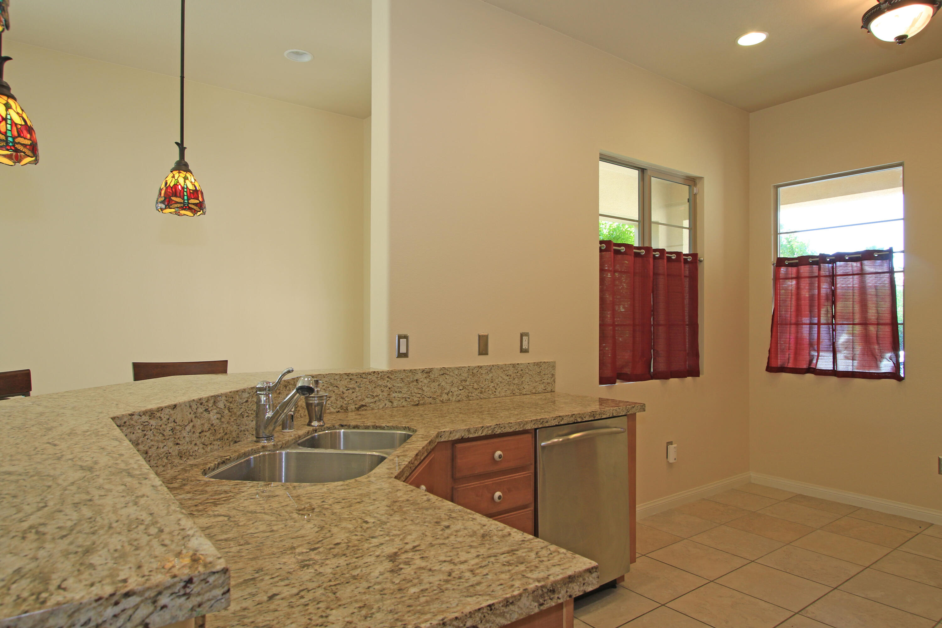 81642 Avenida Bolero Indio, CA 92203 - Photo 14 of 38 a bathroom with a granite countertop sink and a mirror