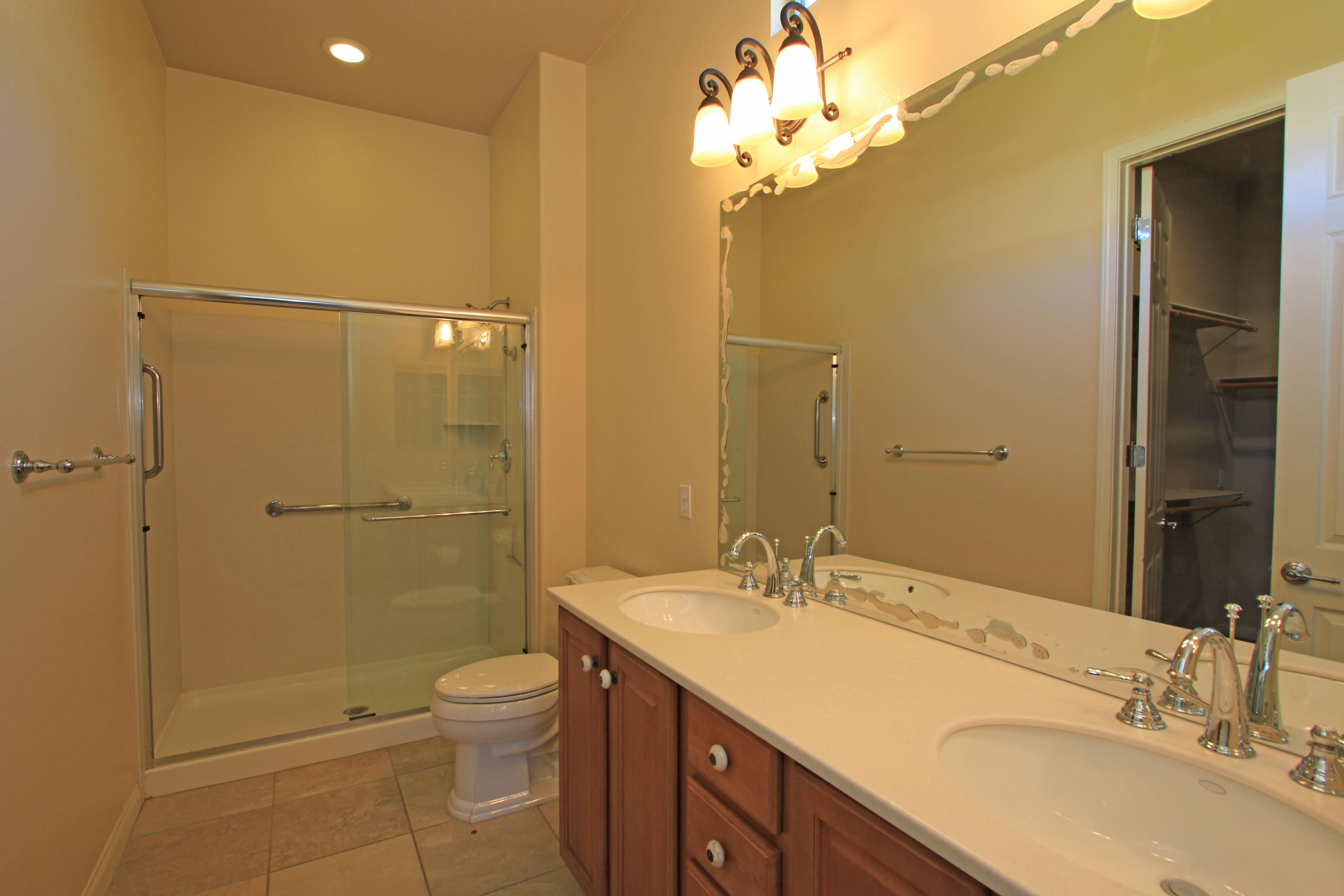 81642 Avenida Bolero Indio, CA 92203 - Photo 23 of 38 a bathroom with a granite countertop sink a toilet and shower