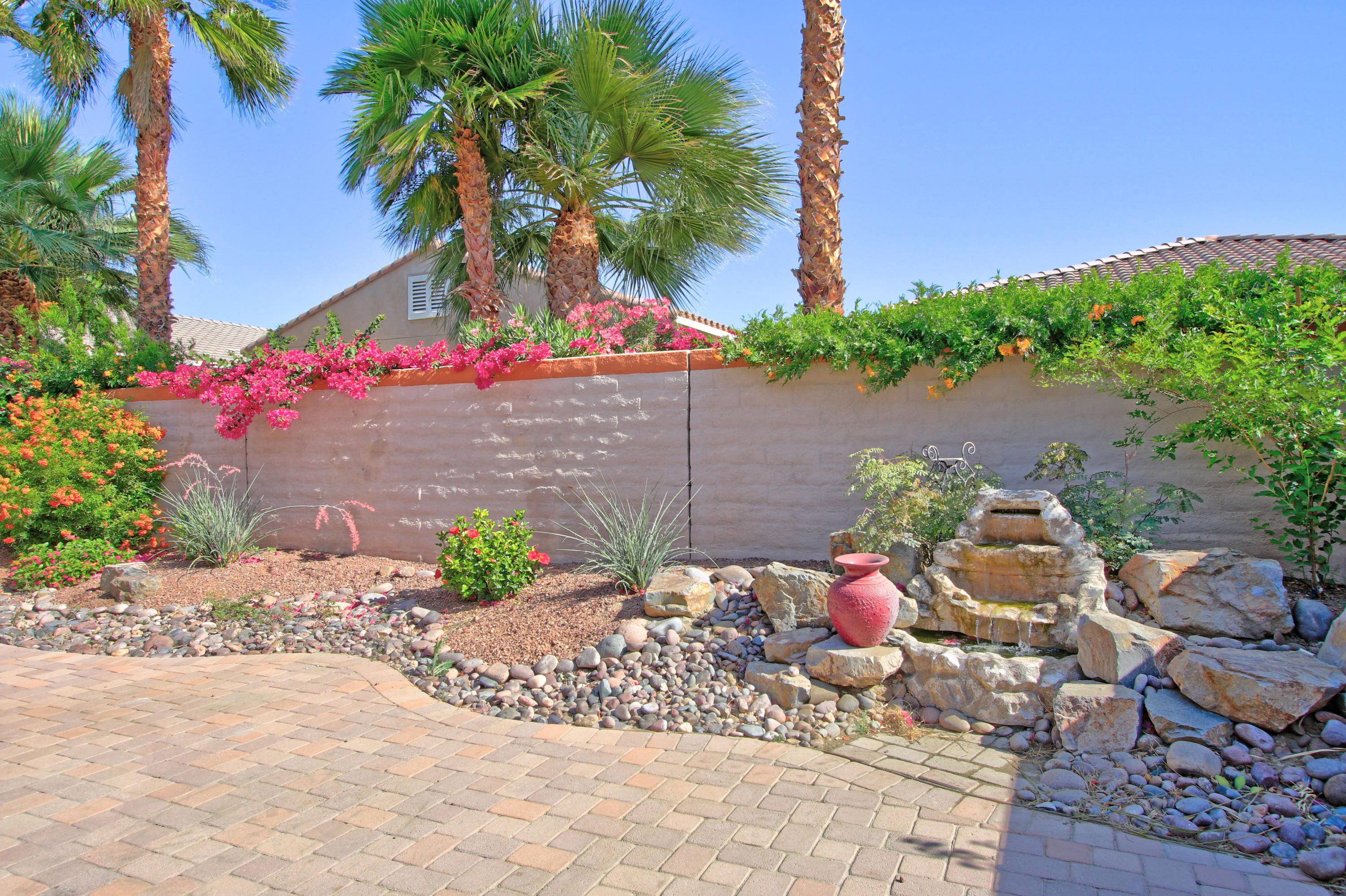 81642 Avenida Bolero Indio, CA 92203 - Photo 36 of 38 a front view of a house with a yard and fountain