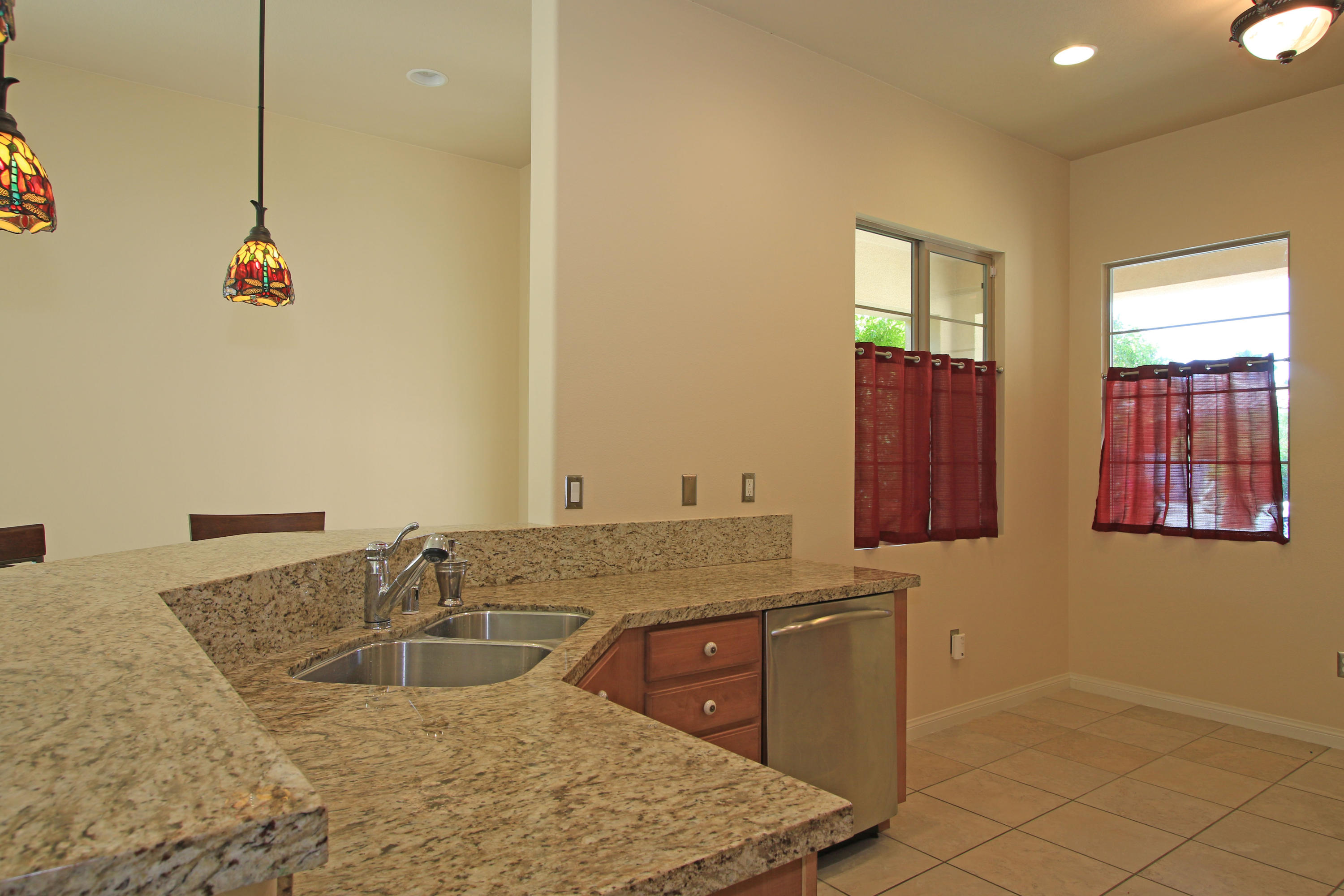 81642 Avenida Bolero Indio, CA 92203 - Photo 5 of 38 a bathroom with a granite countertop sink and mirror