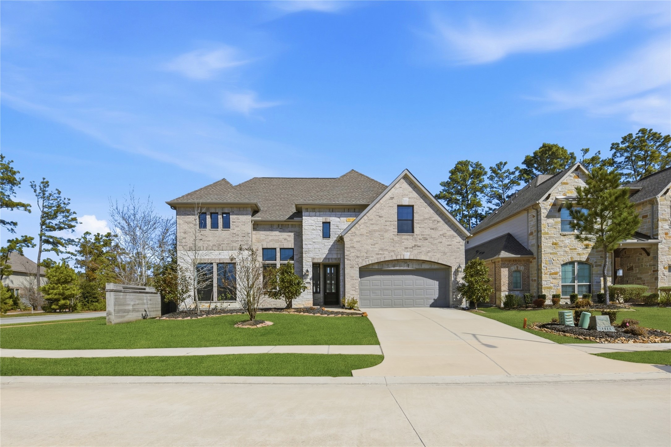 17501 Spice Merlot Lane Conroe, TX 77302 - Photo 5 of 50 a front view of a house with a garden and trees