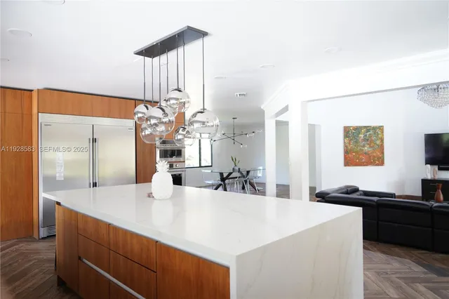 a kitchen with a sink and a refrigerator