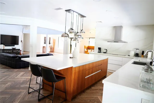a kitchen with a sink refrigerator and cabinets