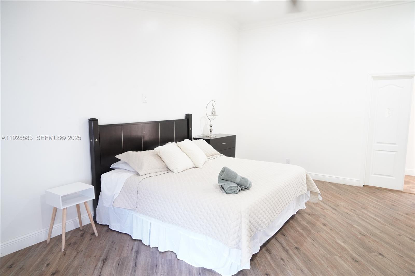 18901 Southwest 50th Street Southwest Ranches, FL 33332 - Photo 19 of 51 a bedroom with a bed and wooden floor