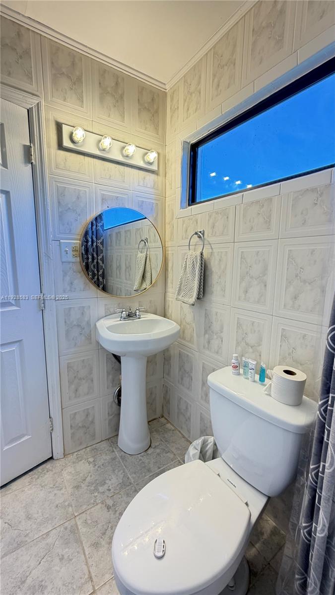 18901 Southwest 50th Street Southwest Ranches, FL 33332 - Photo 22 of 51 a bathroom with a sink toilet and shower