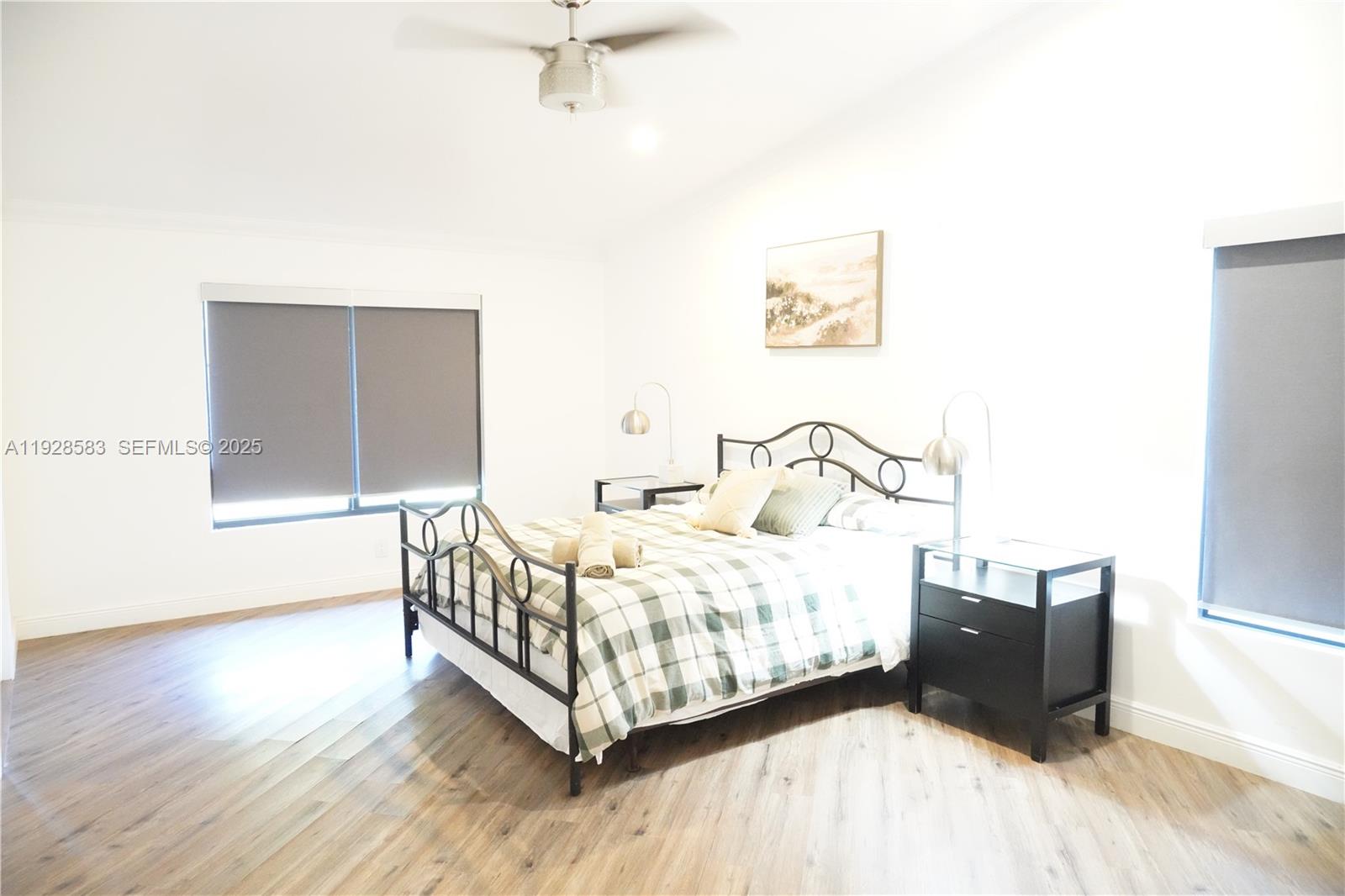 18901 Southwest 50th Street Southwest Ranches, FL 33332 - Photo 29 of 51 a bedroom with a bed lamp and a window