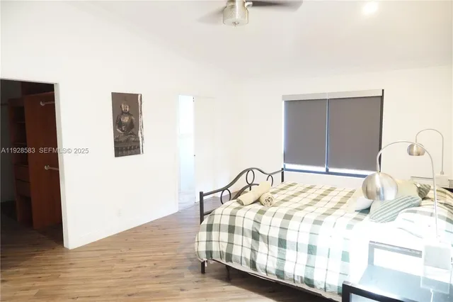 a view of a small space with wooden floor and a window