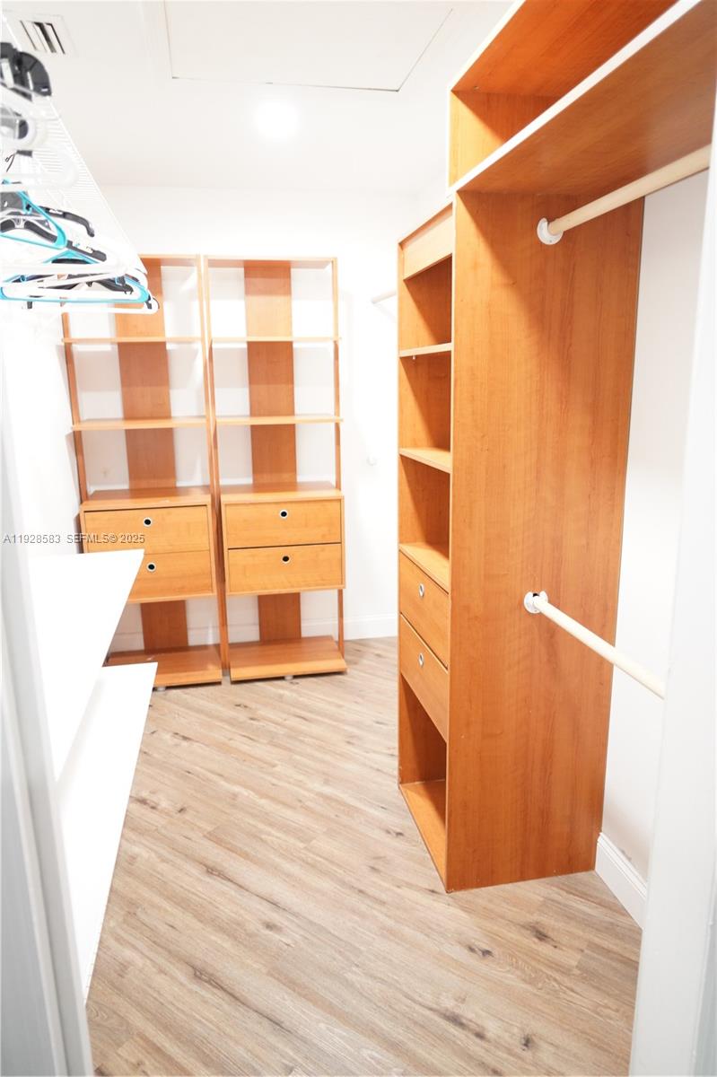 18901 Southwest 50th Street Southwest Ranches, FL 33332 - Photo 32 of 51 a view of a walk in closet with wooden floor