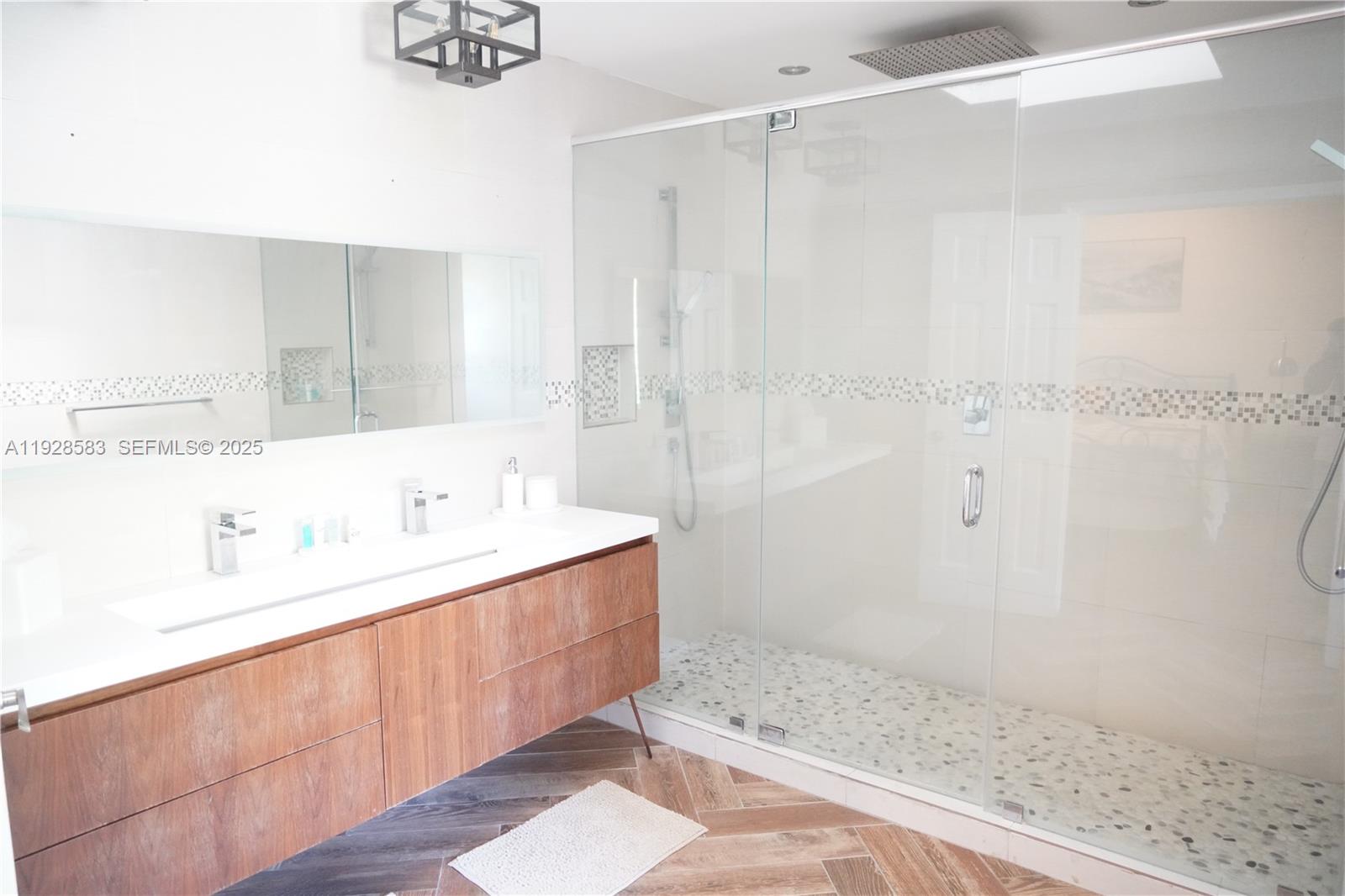 18901 Southwest 50th Street Southwest Ranches, FL 33332 - Photo 33 of 51 a bathroom with a sink a mirror and a shower