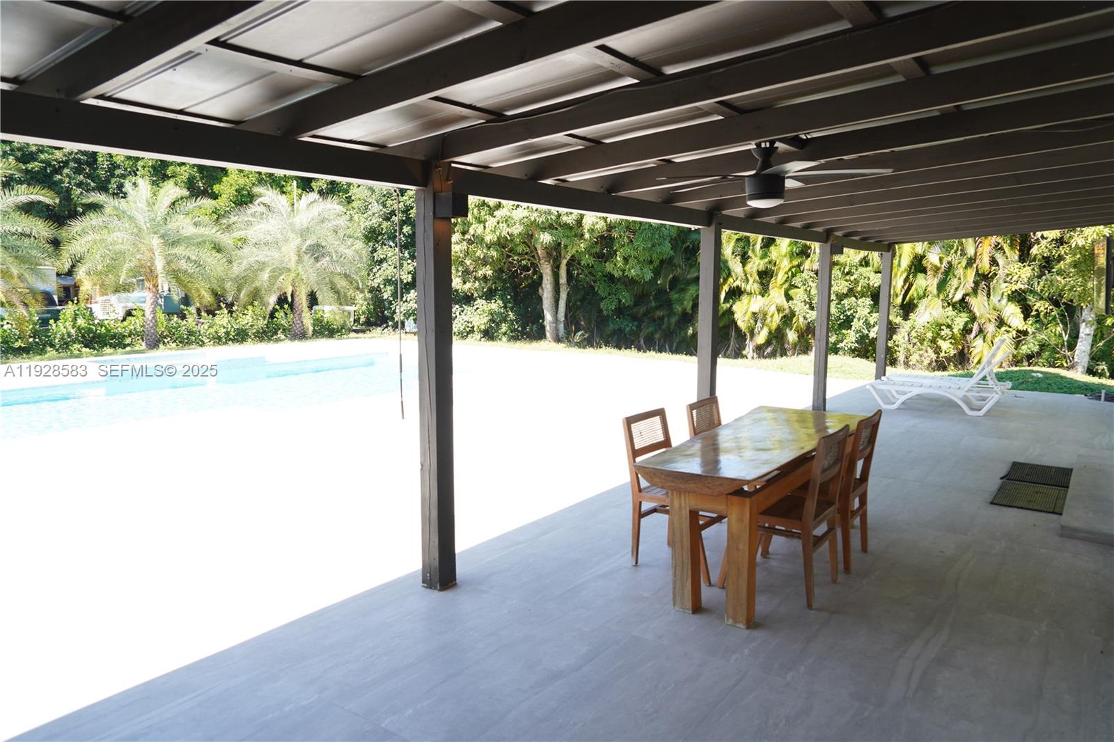 18901 Southwest 50th Street Southwest Ranches, FL 33332 - Photo 38 of 51 a view of a porch with furniture and a yard