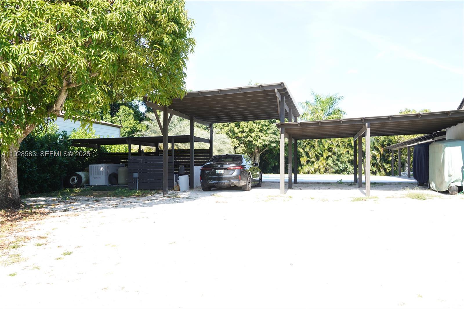 18901 Southwest 50th Street Southwest Ranches, FL 33332 - Photo 44 of 51 a patio with a table and chairs under an umbrella